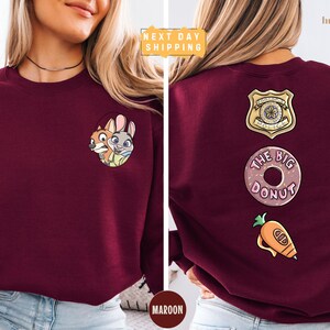 The image is a collage of two photos of a woman wearing a burgundy sweater with various cartoon and food-related designs on the back.