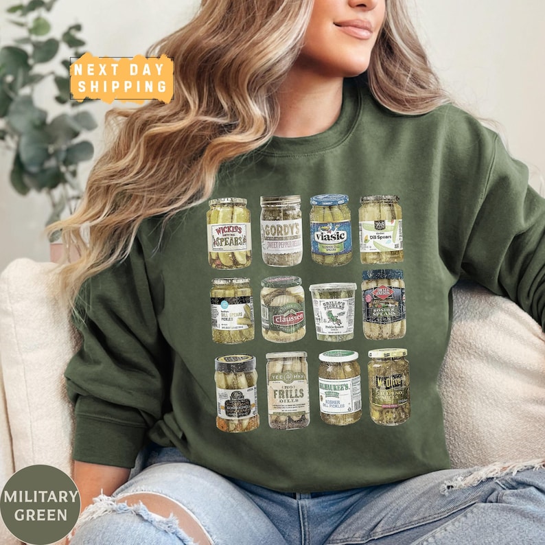 a woman sitting on a couch wearing a green sweatshirt