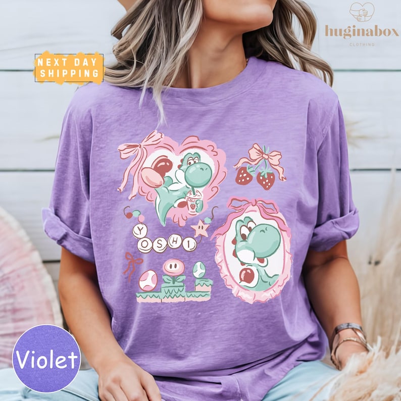 A woman wearing a purple t-shirt with a colorful graphic design featuring characters from the video game series Yoshi.