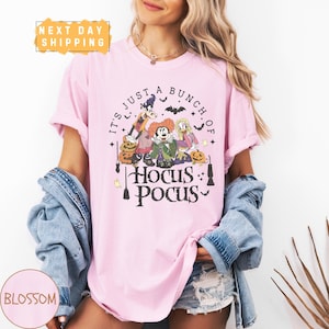 a woman wearing a pink shirt that says it's just a bunch of hoc