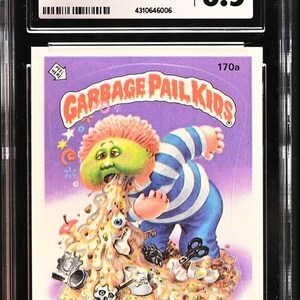 May include: A graded Garbage Pail Kids trading card featuring Richie Retch, a green-skinned character with pink hair, vomiting a pile of garbage. The card is in near mint condition and has a grade of 8.5.
