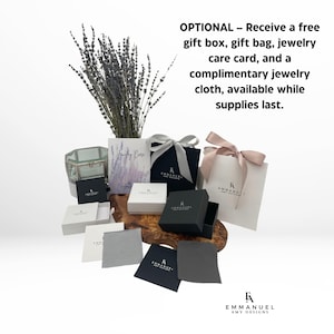 May include: A collection of jewelry packaging including black and white gift boxes, a white gift bag with a pink ribbon, a gray jewelry cloth, and a care card. The text reads: OPTIONAL &ndash; Receive a free gift box, gift bag, jewelry care card, and a complimentary jewelry cloth, available while supplies last. EMMANUEL AMY DESIGNS.