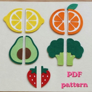 May include: A set of felt cutouts featuring a lemon, orange, avocado, broccoli, and strawberry, each split into two halves. The text PDF pattern is printed in pink in the bottom right corner. These shapes are arranged on a light background.