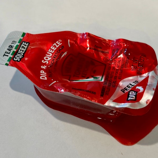 Spilled Ketchup Condiment Cup Packet