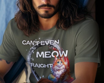 May include: A man wearing a green t-shirt with the text "Can't even meow straight" and a cartoon cat graphic. The man is sitting in a tent.