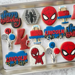 May include: A set of 12 decorated sugar cookies featuring a Spiderman theme. The cookies are decorated with red, blue, and gray icing. The cookies include a happy birthday message, the number 4, the name Lincoln, and a Spiderman character.