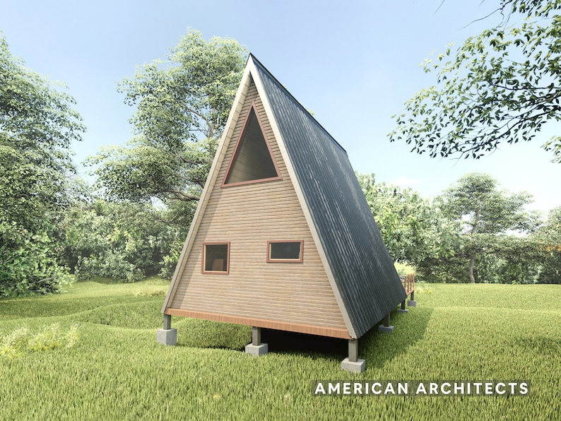 May include: A wooden A-frame cabin with a gray metal roof. The cabin has two windows and a dormer window. The cabin is on a foundation of concrete blocks and is surrounded by green grass.