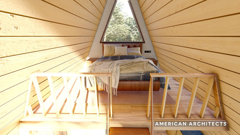May include: A wooden loft bed with a wooden railing and a window above the bed. The bed is made with a blue and white patterned blanket and a brown throw blanket. The room is lined with wood paneling.