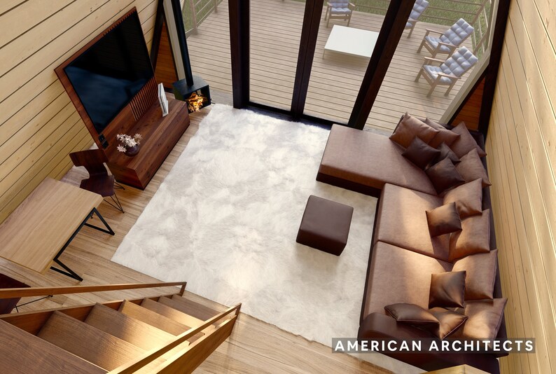 May include: A top-down view of a living room with a large sectional sofa, a white rug, a coffee table, and a television mounted on the wall. The room has a wooden floor and a wooden staircase leading up to the next level. The text "AMERICAN ARCHITECTS" is visible in the bottom right corner of the image.
