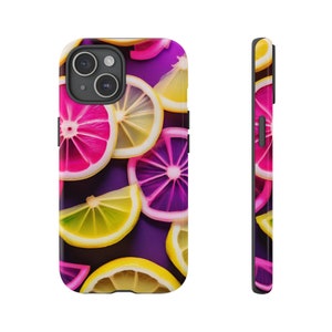 May include: A phone case with a vibrant design featuring overlapping slices of pink, yellow, and purple citrus fruit on a purple background.
