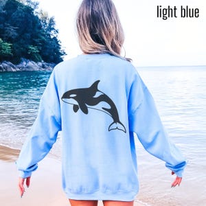 Light blue hoodie with large black Orca design on back and small Orca design on front. Available in Hoodies, sweatshirt and shirts.