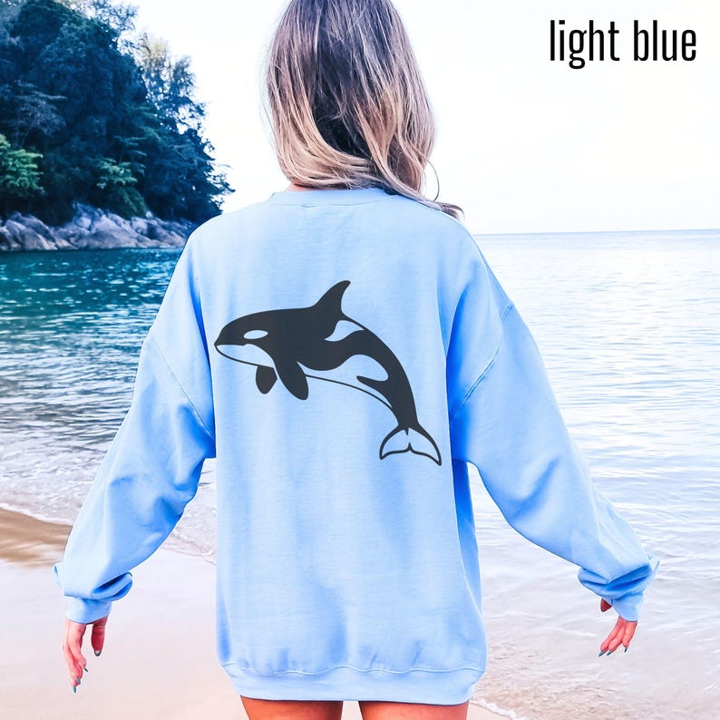 Light blue hoodie with large black Orca design on back and small Orca design on front. Available in Hoodies, sweatshirt and shirts.