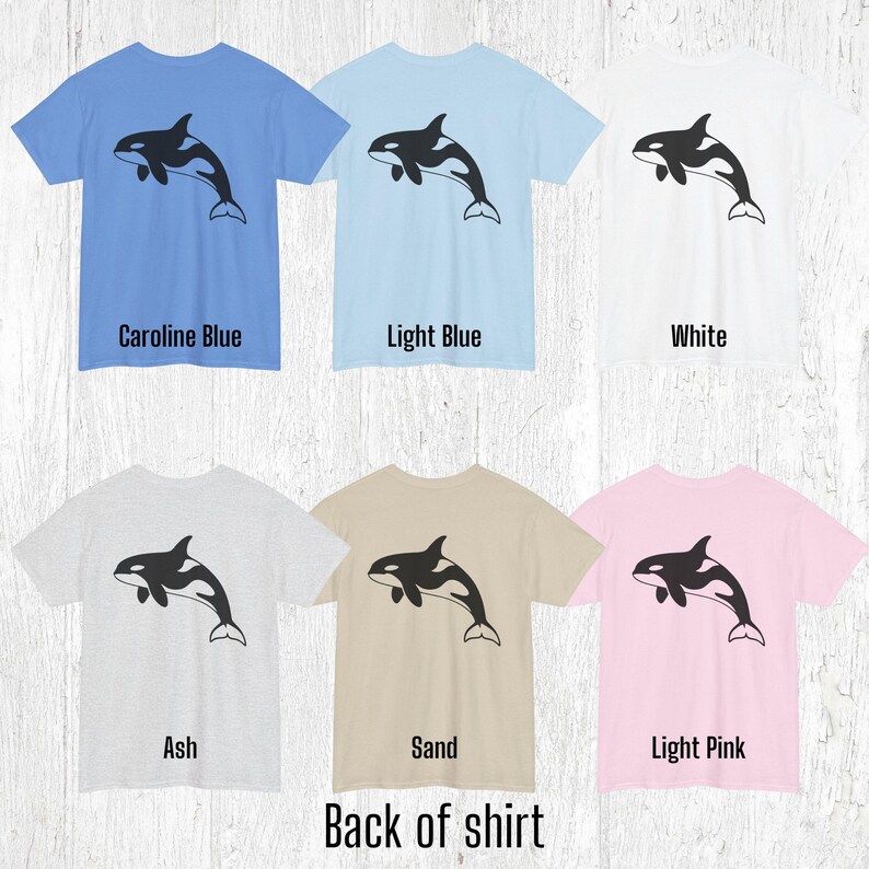 Various color shirts showing large black Orca design on back.