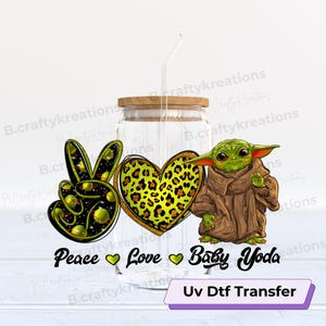May include: A clear glass jar with a wooden lid and a straw. The jar has a peace sign, a heart with a leopard print, and a cartoon Baby Yoda on it. The text "Peace Love Baby Yoda" is printed below the images. The text "Uv Dtf Transfer" is printed on a purple banner below the jar.