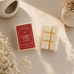 May include: Two clear plastic clamshell containers holding soy wax melts. One container features a red label with white text reading Quimera Candles, Cannelle & Orange, Cire de Soja, Orange, Cannele, Clou, Vanille, 85 g / 3 oz. The other shows six cream-colored wax cubes.
