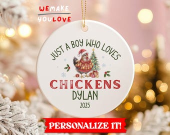 May include: A white ceramic Christmas ornament with a gold string. The ornament features a chicken wearing a Santa hat and sweater, with text that reads "JUST A BOY WHO LOVES CHICKENS DYLAN 2025".