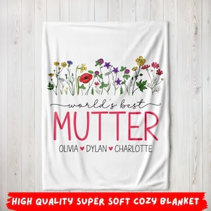 May include: White blanket with a floral design at the top and the words "world's best MUTTER" in pink. Below the word "MUTTER" are the names Olivia, Dylan, and Charlotte. The blanket has the text "HIGH QUALITY SUPER SOFT COZY BLANKET" at the bottom.