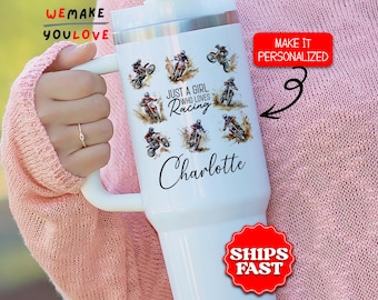 May include: White insulated tumbler featuring motocross racers in action. The tumbler has the text "Just a girl who loves racing" and a personalized name. A red sticker says "Make it personalized".