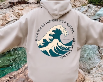 May include: Beige hoodie with a blue wave graphic and the text "When you go through deep waters. Isaiah 43:2 I will be with you."