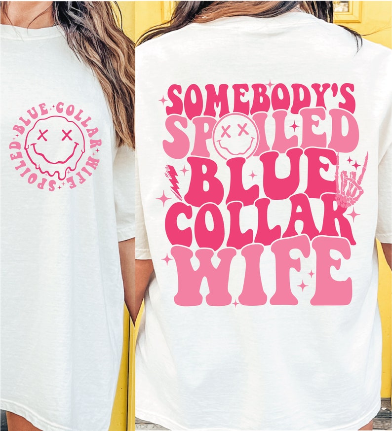 May include: White t-shirt with pink text that reads "Somebody's Spoiled Blue Collar Wife" with a smiley face graphic. The back of the shirt has a smaller smiley face graphic with the text "Spoiled Blue Collar Wife".