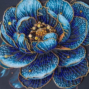May include: Detailed image of a handcrafted floral design. The artwork depicts a large flower with blue and teal petals, edged with gold beads. The flower's centre is filled with gold and yellow beads, and the petals are decorated with small blue beads.