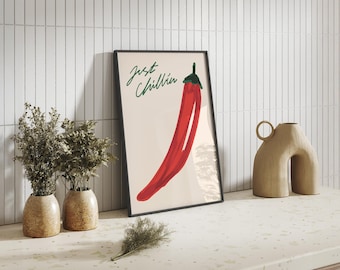 May include: A framed art print featuring a vibrant red chili pepper illustration with the text "Just Chillin" in green script. The artwork is displayed on a white surface with decorative vases.