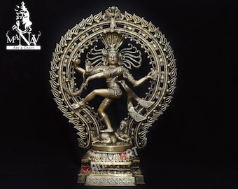 May include: A gold-colored metal sculpture of the Hindu deity Shiva in the Nataraja pose, dancing on a demon. The sculpture is surrounded by a circular halo with intricate details.