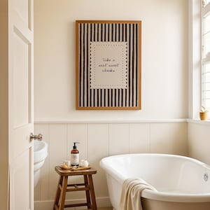 Rustic guest bathroom wall decor with vertical stripe pattern and handwritten toilet humor typography