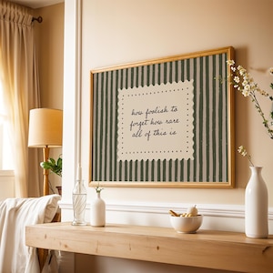 Cozy study room wall decor featuring muted green stripes and soft minimal typography art
