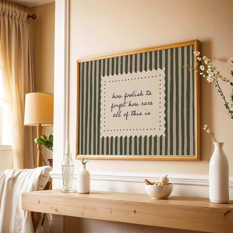 Cozy study room wall decor featuring muted green stripes and soft minimal typography art
