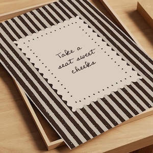 Grandmillennial inspired powder room decor with scalloped frame border and charming bathroom saying