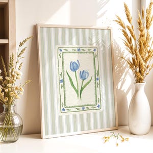 Quiet luxury botanical art print of blue tulips in watercolor style, bordered with scalloped green and blue flowers on soft linen stripe backdrop