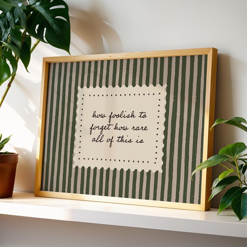 Neutral grandmillennial stripe print featuring muted olive vertical stripes and minimal handwritten script quote decor