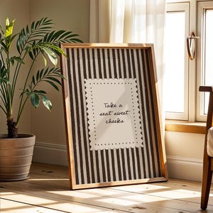 Neutral farmhouse bathroom printable with chocolate brown stripe background and playful powder room quote