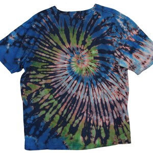 May include: A short-sleeved t-shirt with a spiral tie-dye pattern. The shirt features a blend of blue, green, pink, and black colors. The design radiates from the center of the shirt, creating a unique and colorful look.