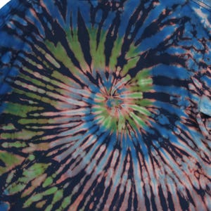 May include: A tie-dye t-shirt with a spiral pattern in shades of blue, green, and pink. The design radiates from the center, creating a psychedelic effect. The shirt's fabric appears soft and comfortable, suitable for casual wear.