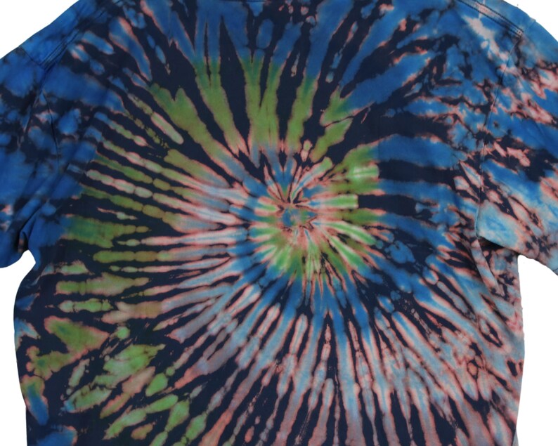 May include: A tie-dye t-shirt with a spiral pattern in shades of blue, green, and pink. The design radiates from the center, creating a psychedelic effect. The shirt's fabric appears soft and comfortable, suitable for casual wear.