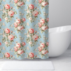 May include: A shower curtain with a floral pattern featuring pink roses on a light blue background.