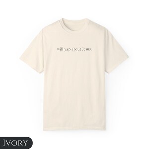 May include: A cream colored t-shirt with the text "will yap about Jesus." printed on the front.