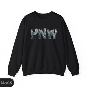 May include: Black sweatshirt with a forest-themed graphic of the letters "PNW" in white.