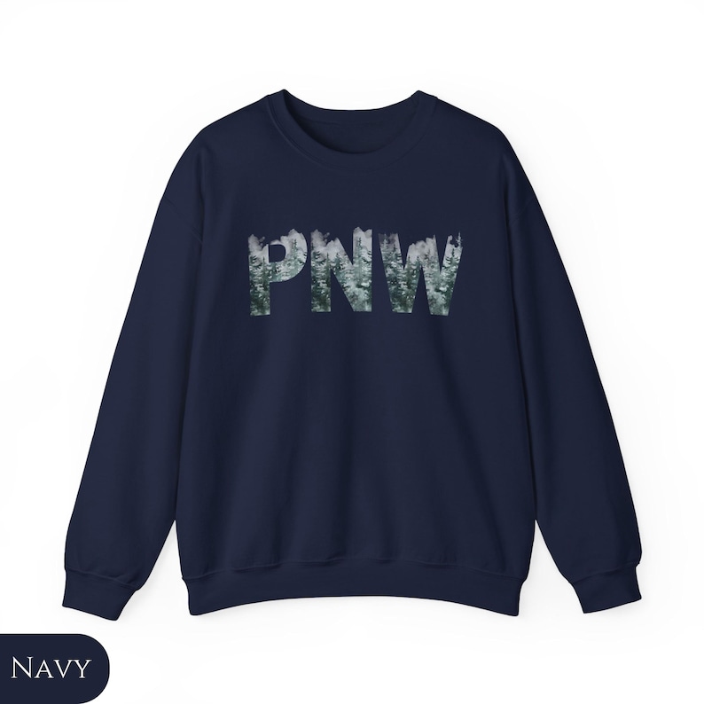 May include: A navy blue sweatshirt with a forest-themed graphic of the letters "PNW" in white.