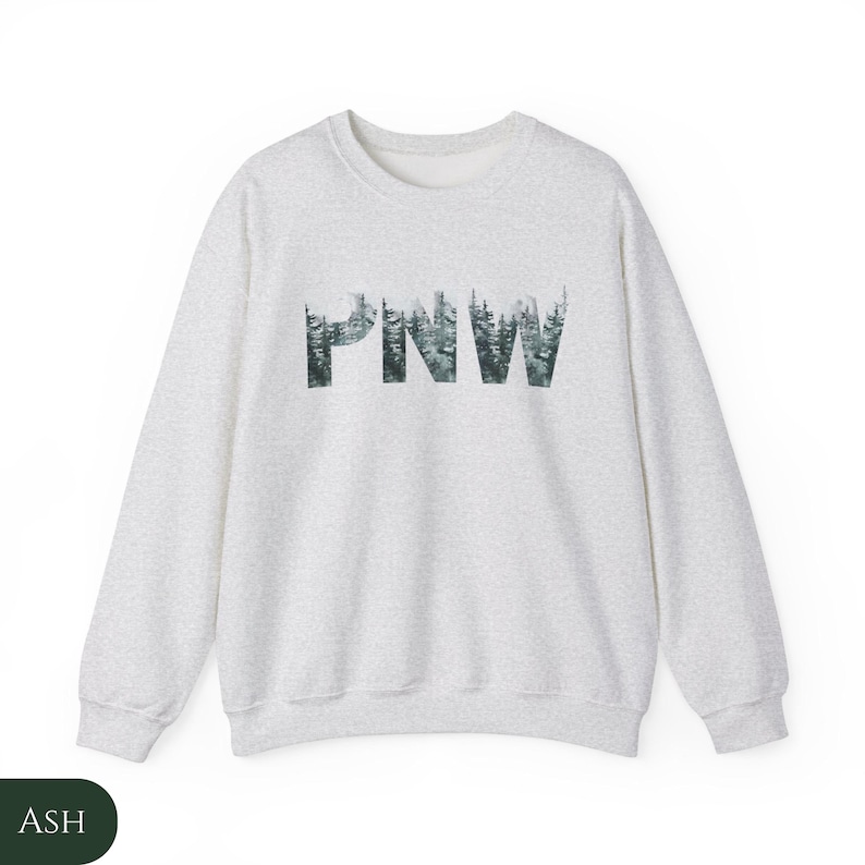 May include: A heather grey sweatshirt with a forest green graphic of the letters "PNW" made up of trees.