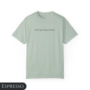 May include: A light green t-shirt with the text "will yap about Jesus." printed on the front.