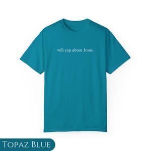 May include: A turquoise blue t-shirt with the text "will yap about Jesus." printed in white on the front.