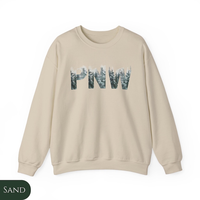 May include: A sand colored sweatshirt with a graphic print of the letters "PNW" made up of a forest scene.