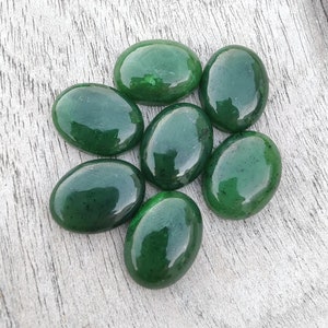 May include: Seven smooth, oval-shaped green jade stones. The stones are polished and have a glossy finish.