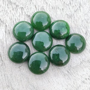 May include: Eight smooth, round, green jade stones. The stones are polished and have a glossy finish.