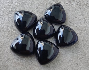 May include: Six black triangular glass gems with a glossy finish.
