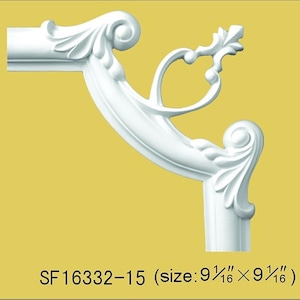 May include: A white corner molding piece featuring an ornate scrollwork design with leaf-like details and a central pointed finial. The product is labeled with the text SF16332-15 and dimensions of 9 1/16 inches by 9 1/16 inches.