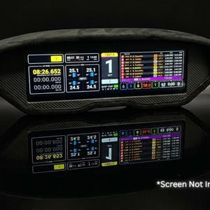 May include: A black carbon fiber textured racing dashboard display housing with a wide rectangular opening for a screen. The housing features a sleek, curved design and a matte finish, designed to hold a digital telemetry display unit.
